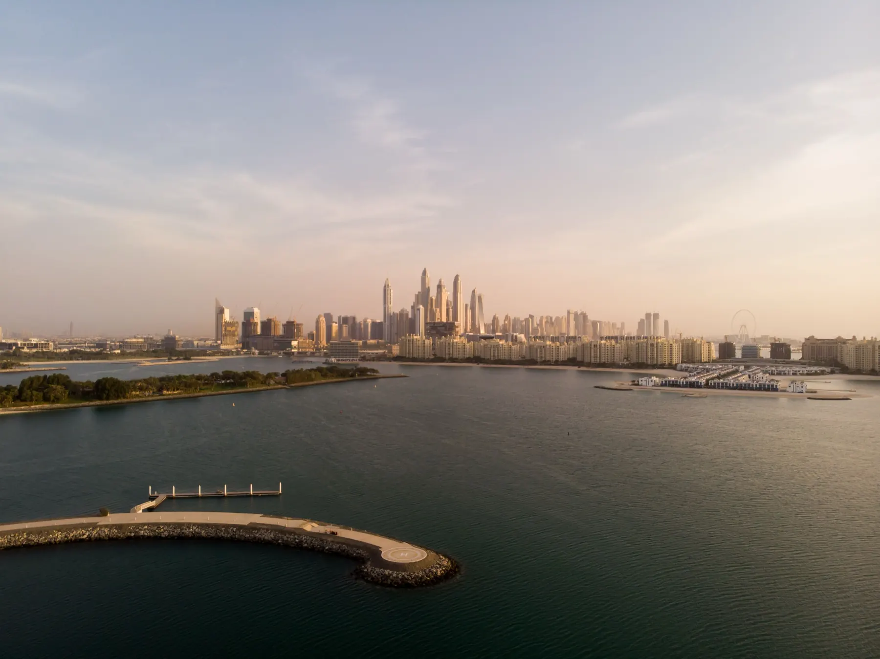 Aerial view of the Dubai skyline at dawn across open water