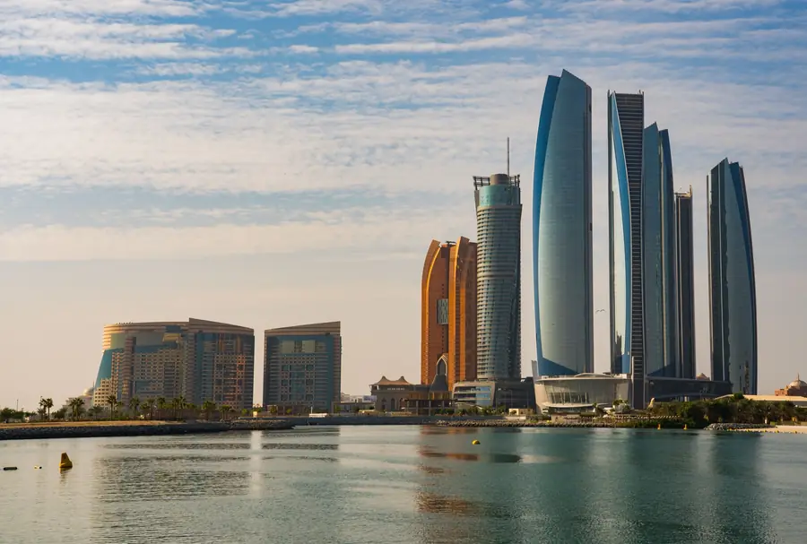 The Abu Dhabi skyline seen across the water at dusk