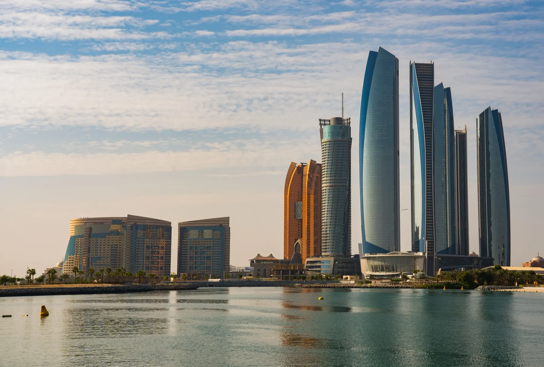 The Abu Dhabi skyline seen across the water at dusk