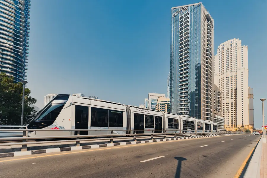 A tram running along Sheikh Zayed Road past Dubai high-rises