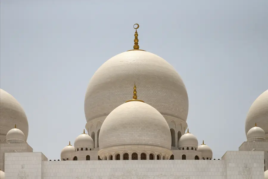 The white marble domes of the Sheikh Zayed Grand Mosque